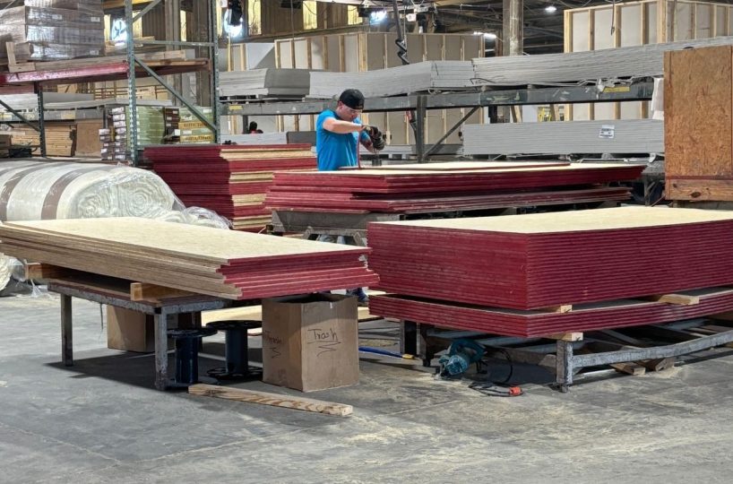 Factory-built home components being prepared indoors using controlled construction methods